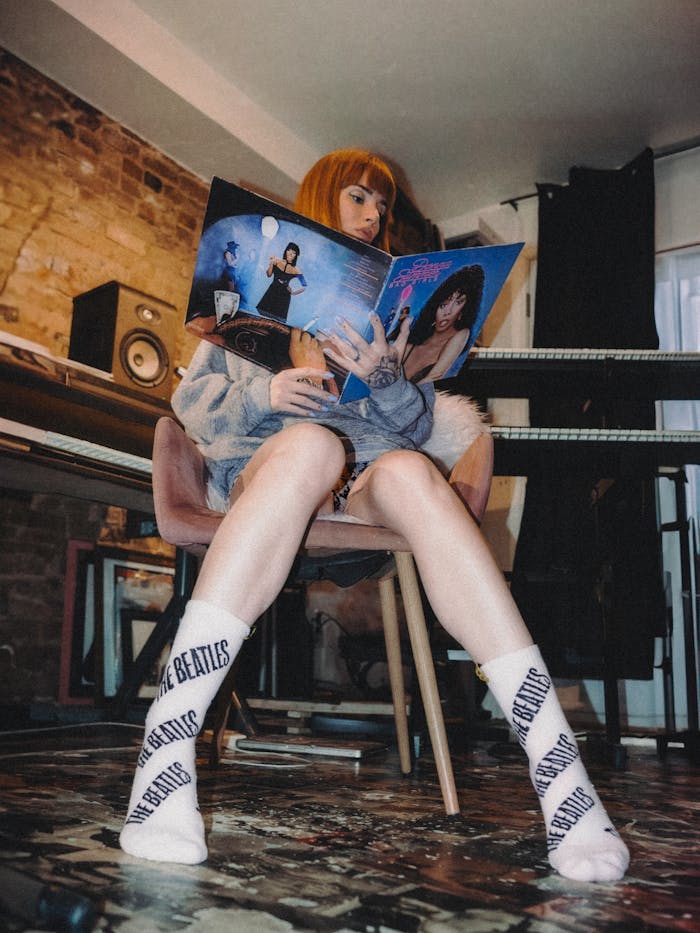 A woman sitting on a chair with socks on